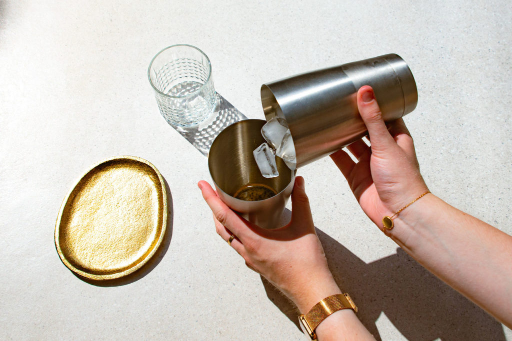 mixing of the ice cubes in the shaker with a double espresso to prepare a caffè shakerato