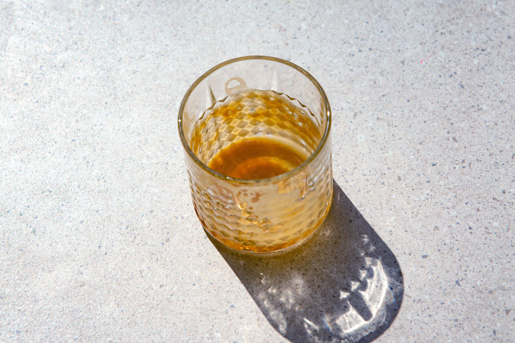 an empty glass with leftovers of foam from a shakerato